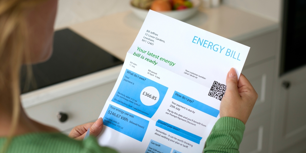 A woman is reading her energy bill