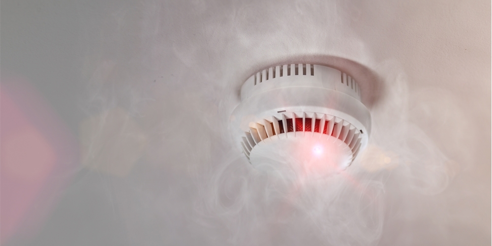 A smoke detector and fire alarm in action