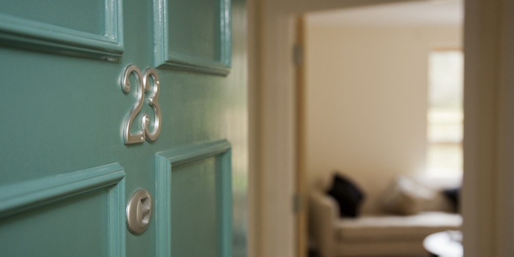 An open front door to an over 55 housing apartment