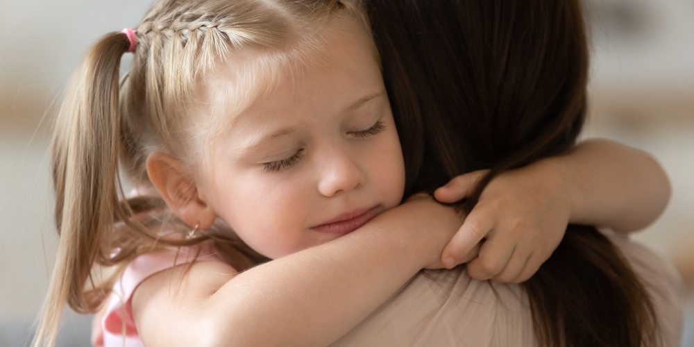 A young daughter hugging her mum